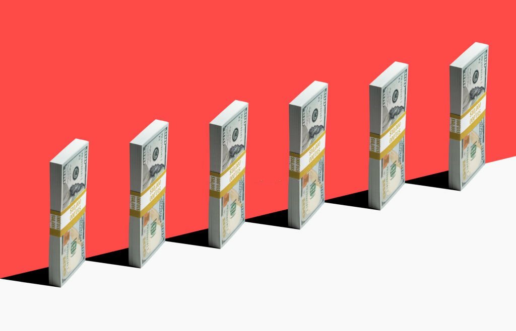 6 bundles of US $100 bills standing vertically on the edge of the white shelf, a red background